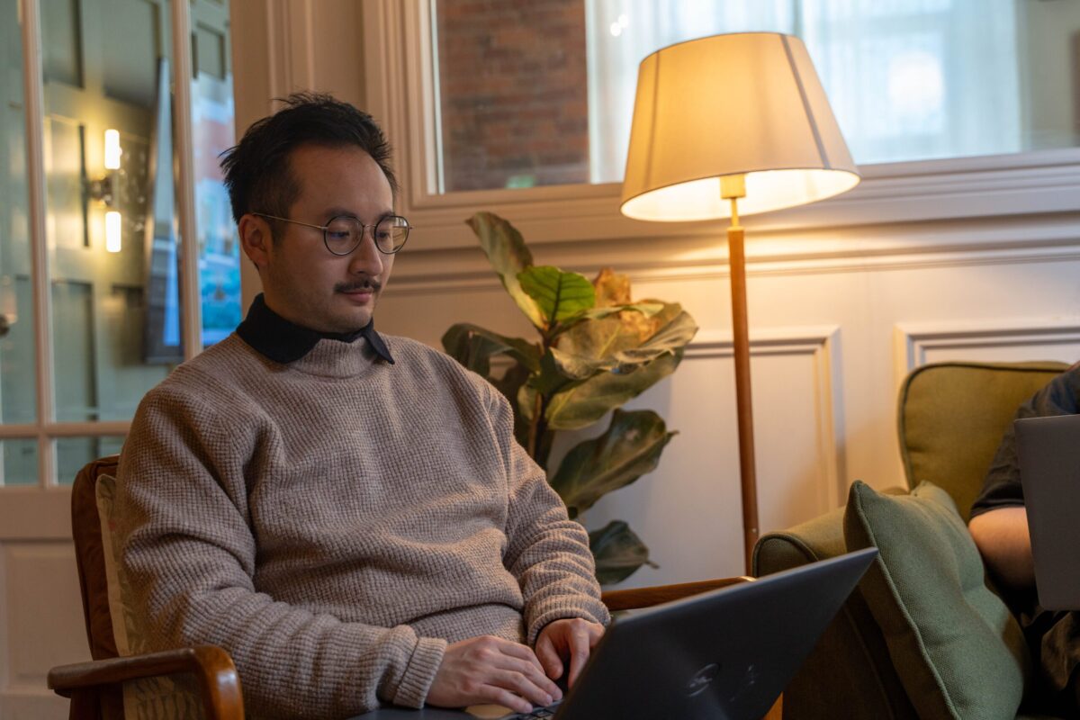 Ryan sat on chair with laptop