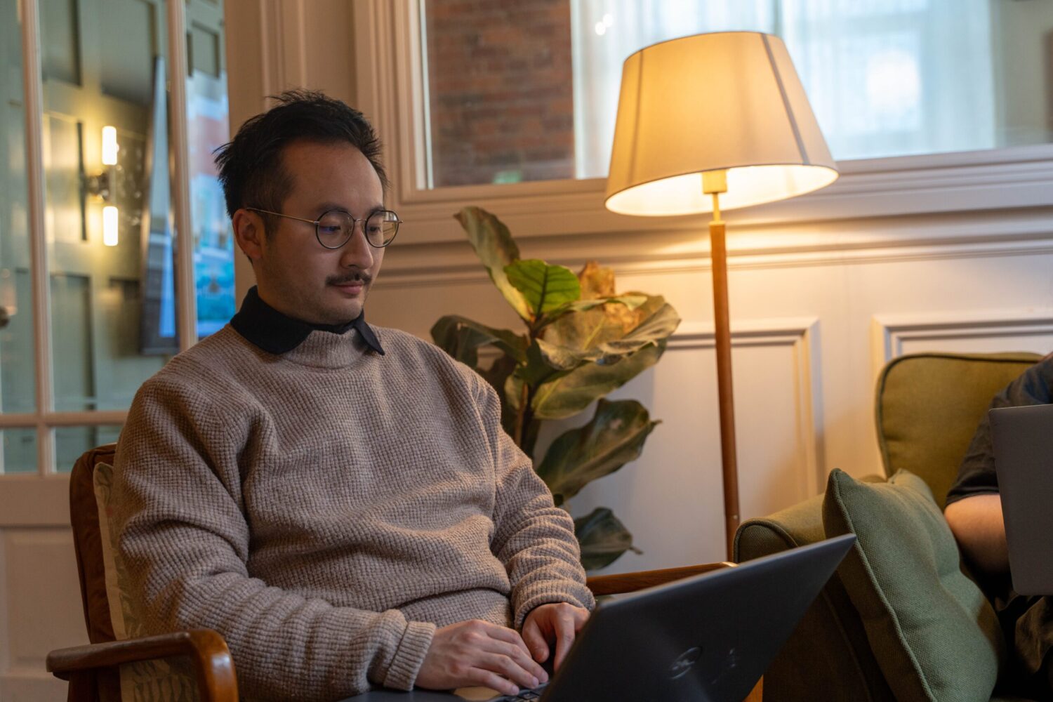 Ryan sat on chair with laptop
