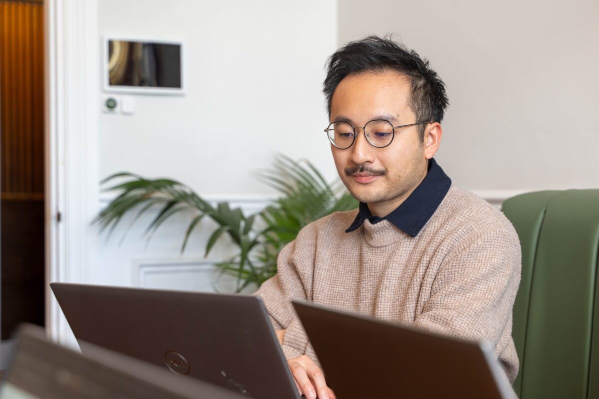 Ryan working on his laptop in a meeting room